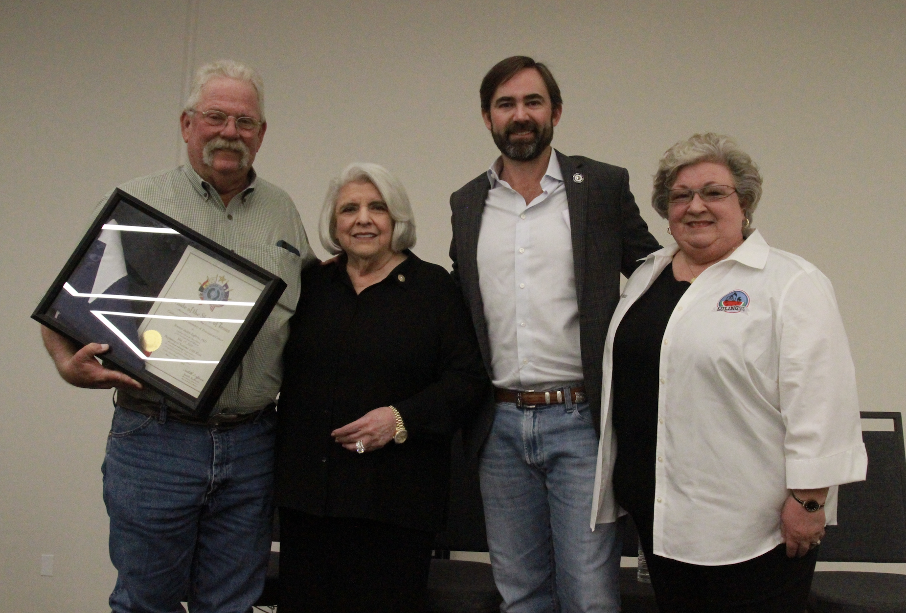 County officials at the dedication ceremony with a commemorative framed flag